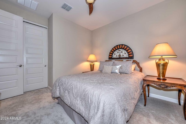 carpeted bedroom with baseboards, visible vents, and a closet