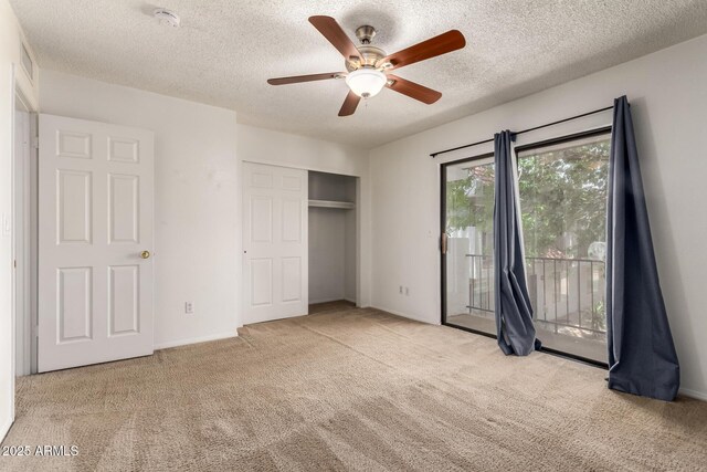 18239 N 40th St Unit 122, Phoenix, AZ 85032 - unfurnished bedroom featuring access to exterior, carpet flooring, a textured ceiling, a closet, and a ceiling fan