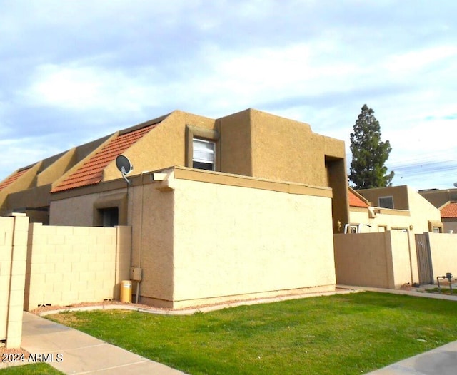 view of home's exterior with a yard