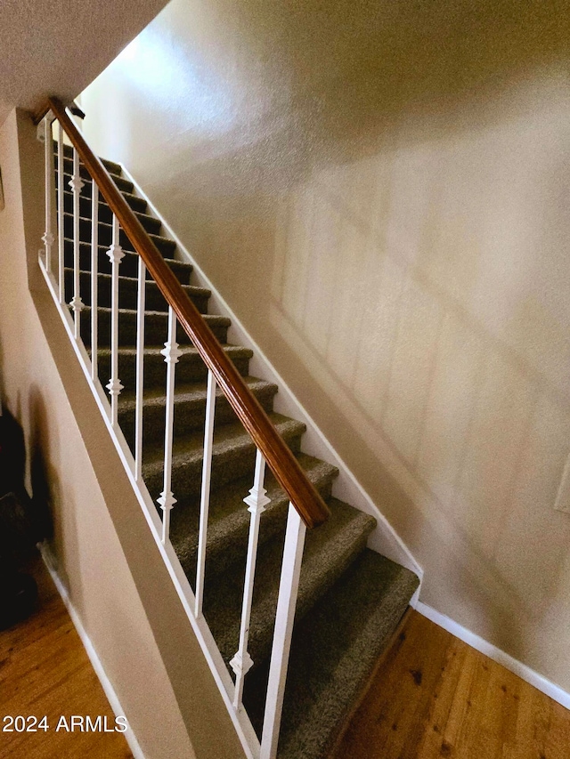 stairway with hardwood / wood-style floors