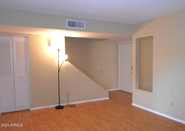 basement with hardwood / wood-style floors