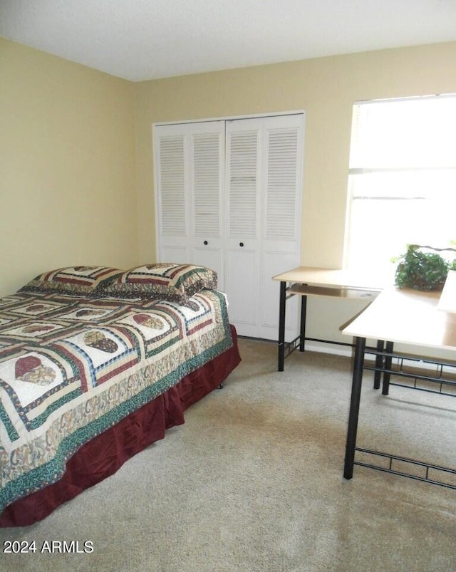 carpeted bedroom featuring a closet