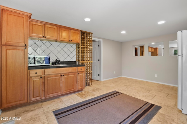 106 N Lariat Way, Payson, AZ 85541 - kitchen with brown cabinetry, backsplash, baseboards, stainless steel microwave, and recessed lighting