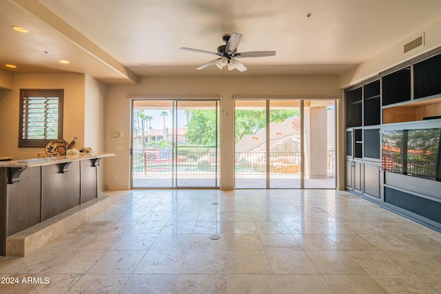 interior space with ceiling fan