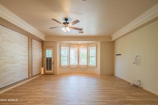 empty room featuring ceiling fan and light hardwood / wood-style flooring