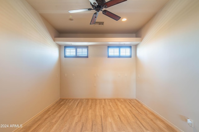 spare room with ceiling fan and light wood-type flooring