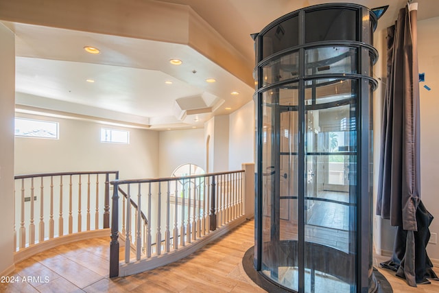 hallway featuring light wood-type flooring and a wealth of natural light