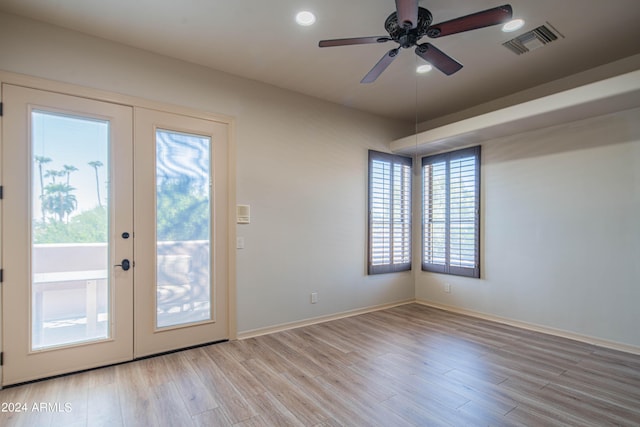 entryway featuring french doors, ceiling fan, and light hardwood / wood-style flooring