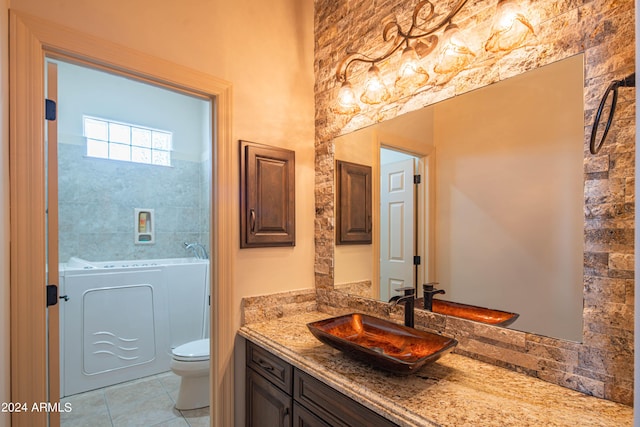 bathroom with vanity, washer / clothes dryer, tile patterned floors, and toilet