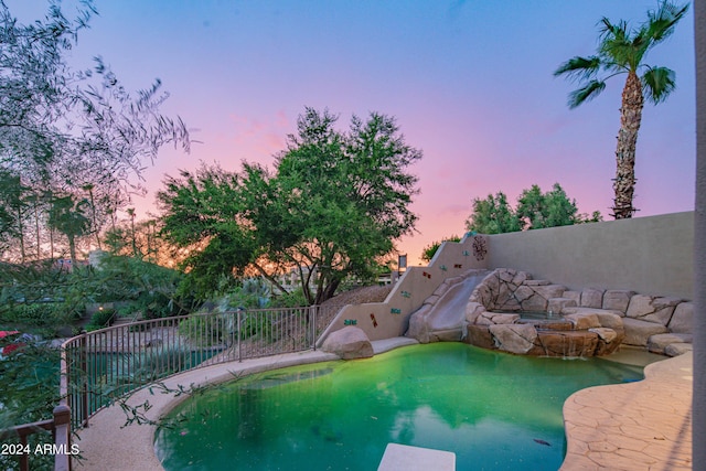 view of pool at dusk