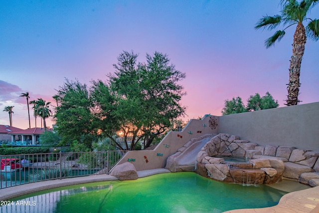 view of pool at dusk