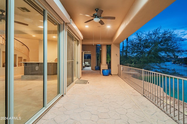 balcony at dusk with a patio and ceiling fan