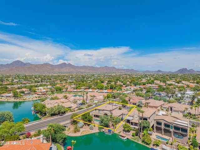 drone / aerial view featuring a water and mountain view