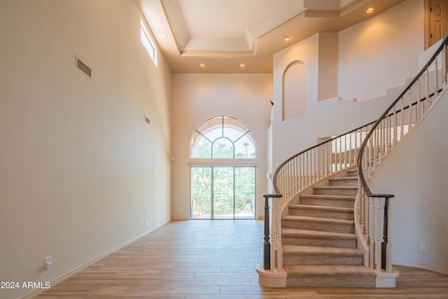 interior space featuring hardwood / wood-style flooring and a high ceiling