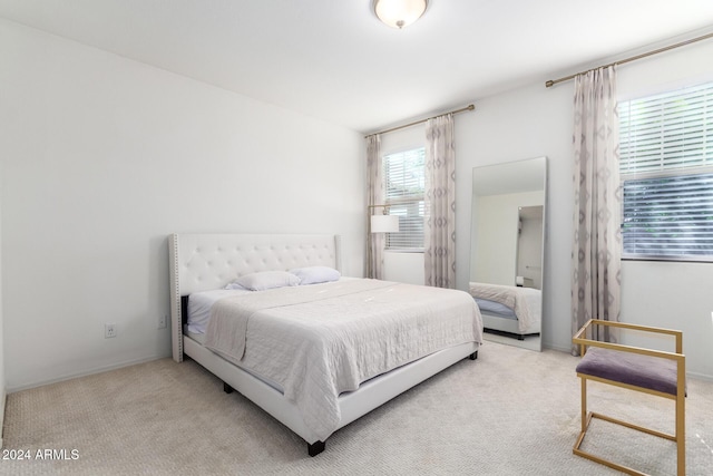 bedroom featuring light colored carpet