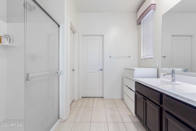 bathroom with tile patterned floors, vanity, and walk in shower