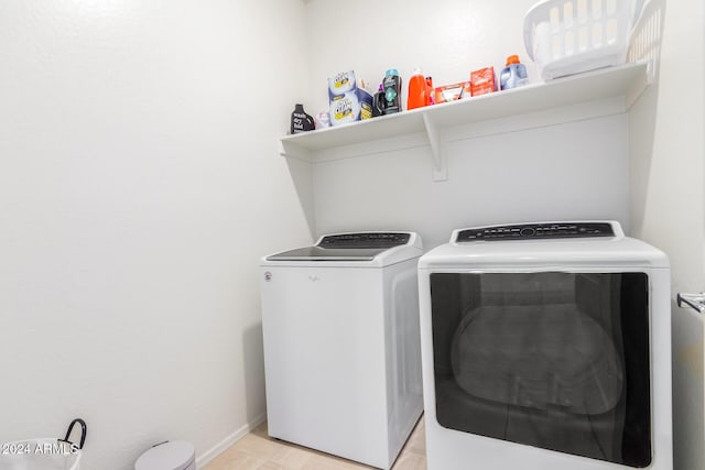 clothes washing area featuring washer and clothes dryer