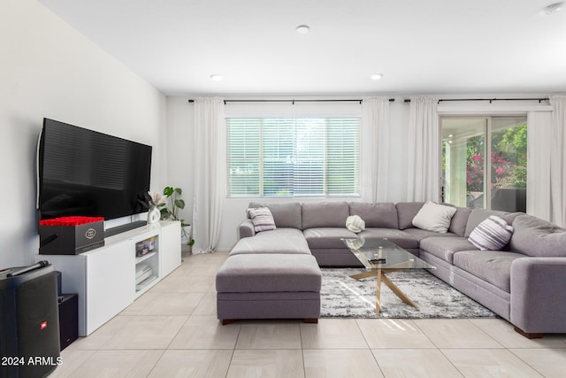 living room featuring light tile patterned flooring and a healthy amount of sunlight