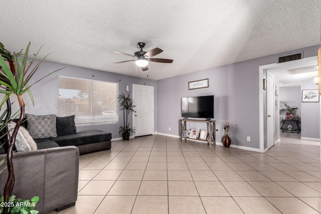 617 E Calle Adobe Ln, Goodyear, AZ 85338 - living room featuring ceiling fan, light tile patterned flooring, and a textured ceiling
