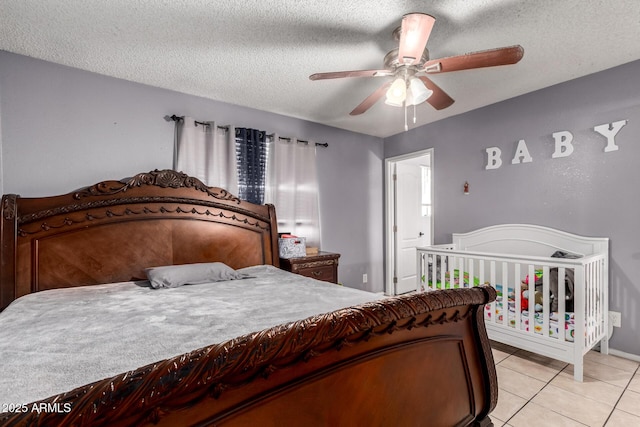 617 E Calle Adobe Ln, Goodyear, AZ 85338 - bedroom with a textured ceiling, light tile patterned floors, and a ceiling fan