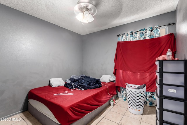 617 E Calle Adobe Ln, Goodyear, AZ 85338 - tiled bedroom featuring a textured ceiling and ceiling fan