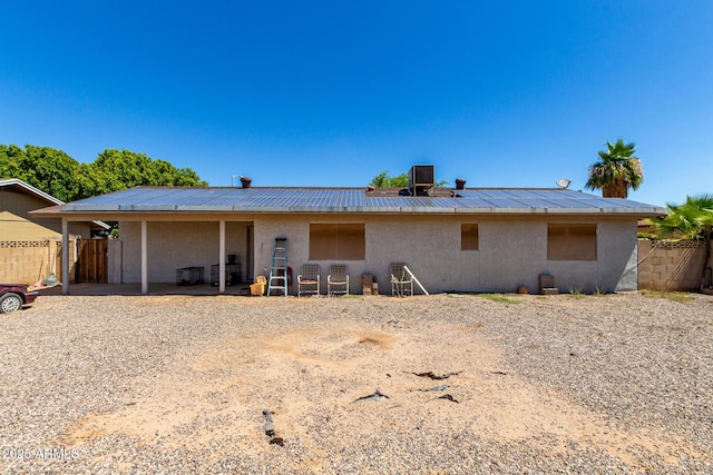 617 E Calle Adobe Ln, Goodyear, AZ 85338 - rear view of house with stucco siding, a metal roof, and a standing seam roof