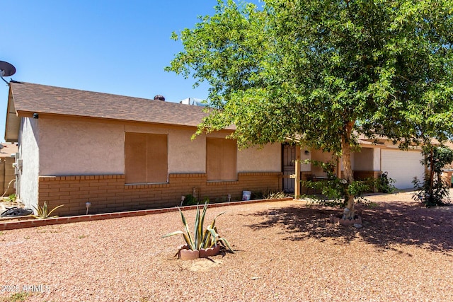 617 E Calle Adobe Ln, Goodyear, AZ 85338 - view of front of home with brick siding, stucco siding, and an attached garage