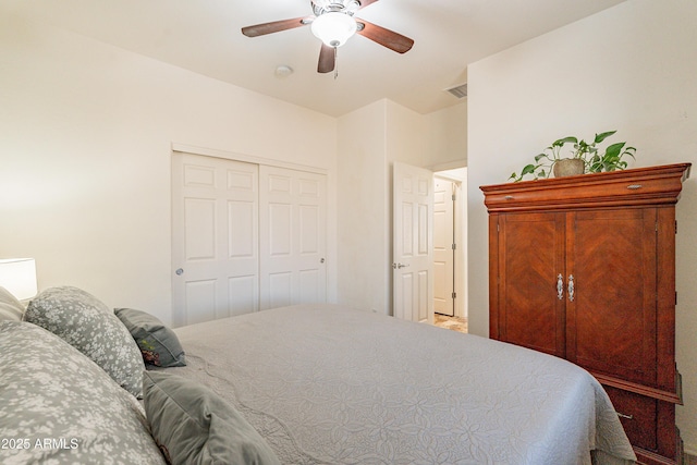 bedroom with a closet, visible vents, and a ceiling fan