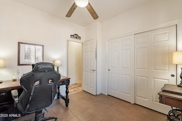 home office featuring baseboards, ceiling fan, and light tile patterned flooring