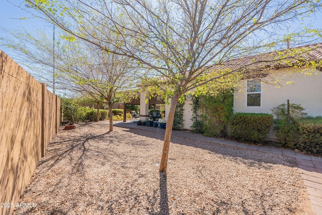 view of yard featuring a patio and fence