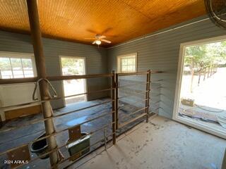 interior space with ceiling fan