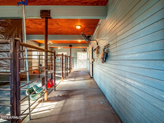 hallway with wood walls