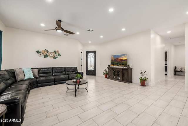 living area with a ceiling fan, recessed lighting, and visible vents