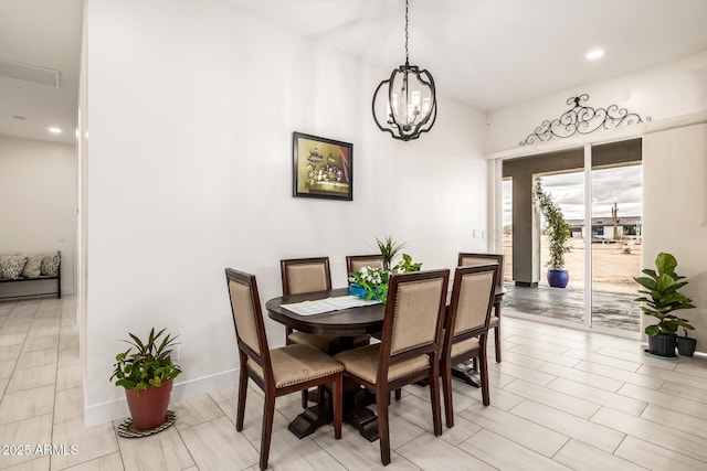 dining room with an inviting chandelier and baseboards