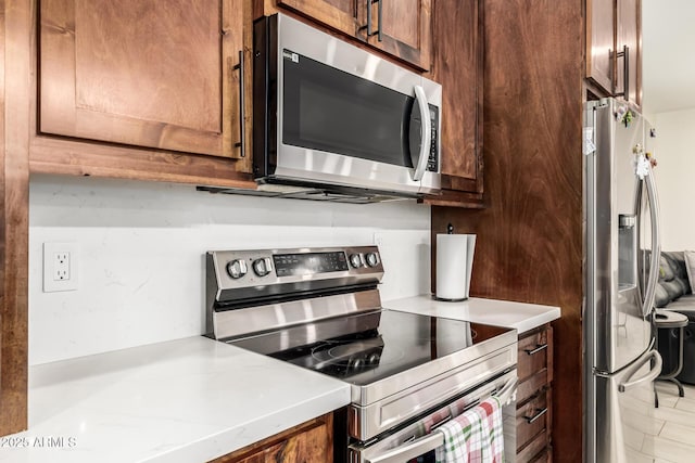 kitchen featuring light countertops and stainless steel appliances