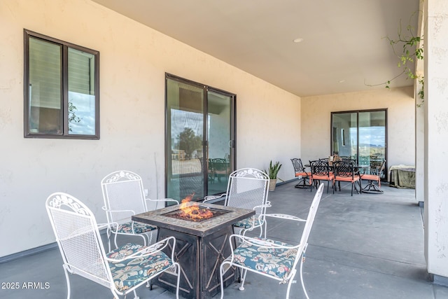 view of patio featuring an outdoor fire pit and outdoor dining area