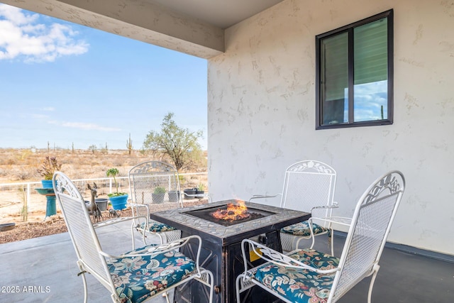 balcony featuring a patio and a fire pit