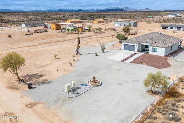 drone / aerial view with view of desert and a mountain view