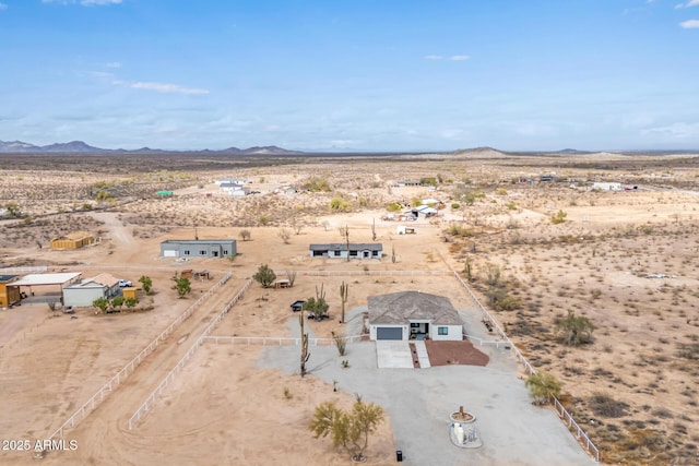 bird's eye view featuring a mountain view, a desert view, and a rural view