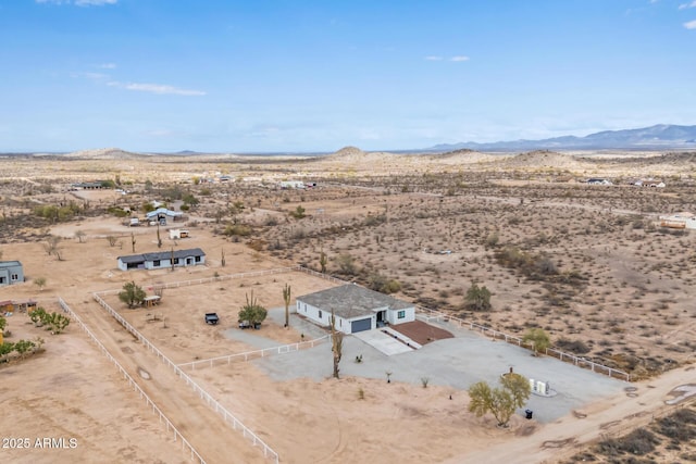 aerial view featuring a mountain view, a rural view, and view of desert