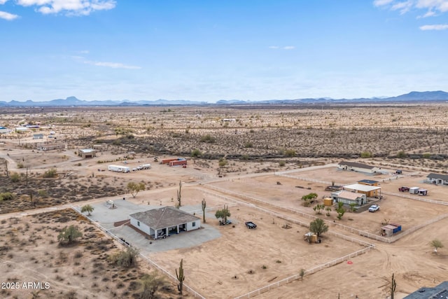 drone / aerial view with a mountain view, a desert view, and a rural view