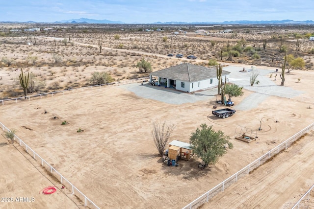 bird's eye view featuring a mountain view, a desert view, and a rural view