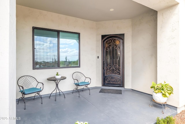 property entrance with stucco siding