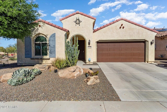 mediterranean / spanish-style house featuring a garage