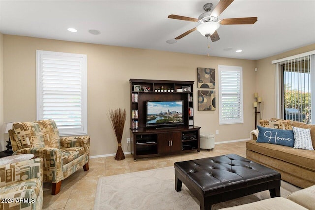 tiled living room with a healthy amount of sunlight and ceiling fan