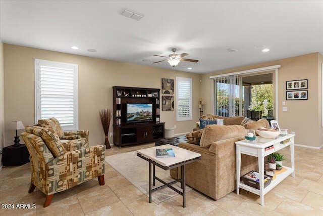 living room featuring plenty of natural light and ceiling fan