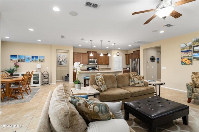 tiled living room featuring ceiling fan