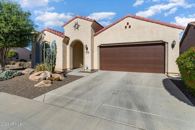 mediterranean / spanish-style home featuring a garage