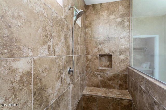 bathroom with tiled shower