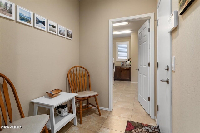 hall with light tile patterned floors